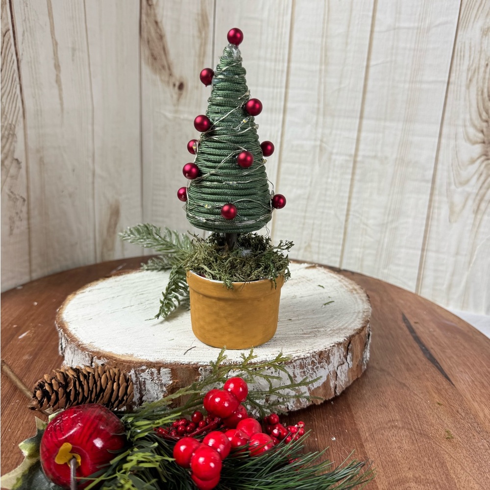 Festive Green Miniature Christmas Tree with Red Accents with lights